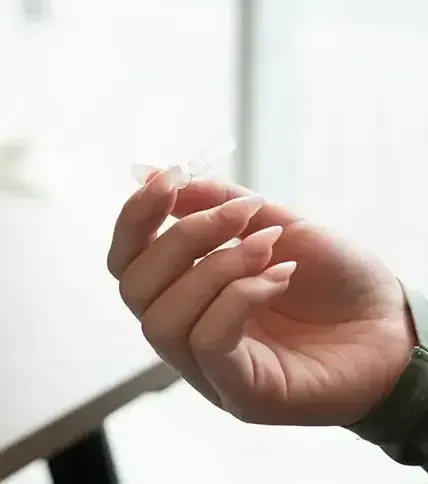 Invisalign clear aligner tray held up to the light