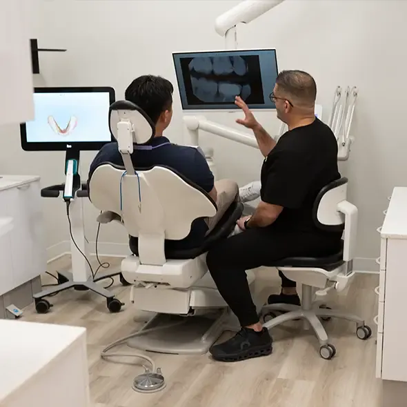 Dr Daniel Lawen reviewing xray with potential patient for wisdom tooth removal
